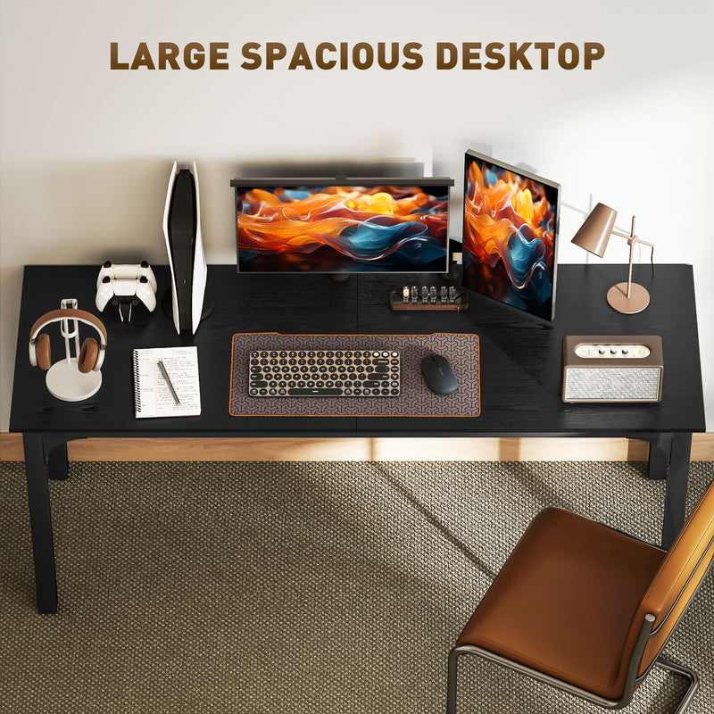 Large black desk with office equipment on a neutral background