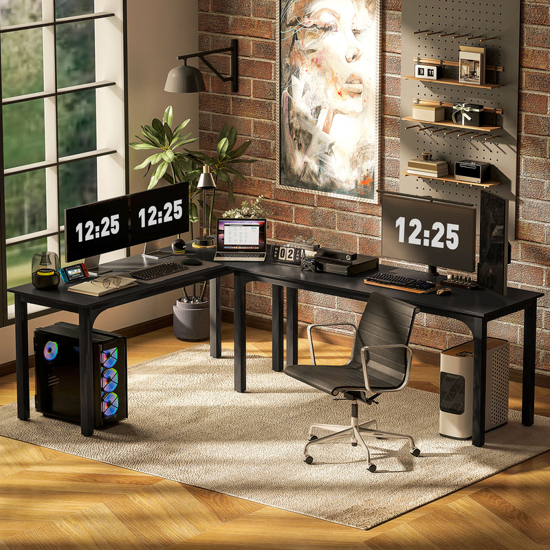 Modern home office with a black L-shaped desk, computer setup, and decorative elements.