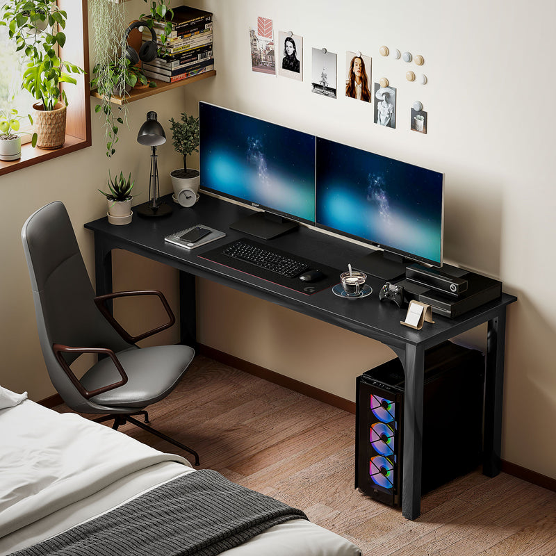 Modern bedroom with a black desk featuring two computer monitors, a chair, and decorative elements.