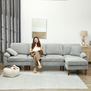 Woman sitting on light grey sectional sofa with chaise lounge and reading a book. 