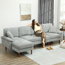 Modern living room with a light grey sectional sofa, coffee table, and decorative elements.