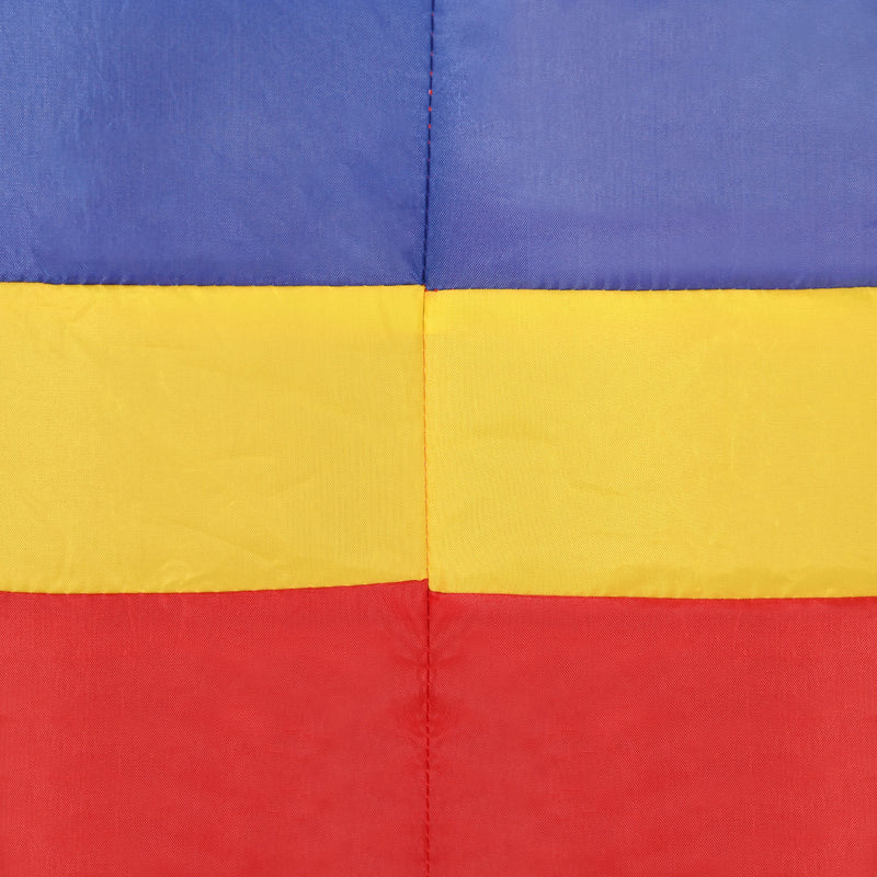 Close-up of a colorful quilt with blue, yellow, and red squares.