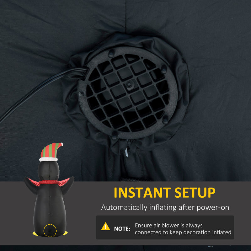 Black inflatable decoration with air blower and penguin figure, featuring text on instant setup.