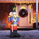 Giant inflatable Christmas display nutcracker decoration in front of a house with Christmas decorations.