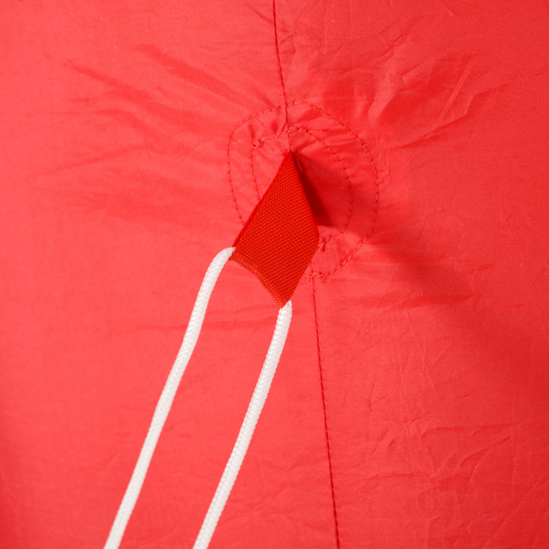 Close-up of a red kite with a white string on a red background