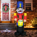Inflatable Christmas display nutcracker decoration in front of a brick house with Christmas lights.