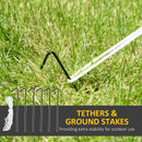 White tethers with black ground stakes on grass, text 'Tethers & Ground Stakes' and 'Providing extra stability for outdoor use'.