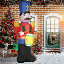 Inflatable Christmas display nutcracker decoration in front of a brick house with Christmas decorations.