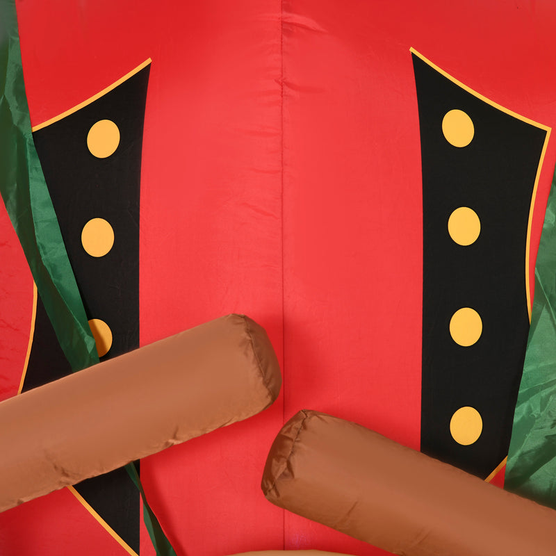 Inflatable Christmas display costume with red, green, and black colors featuring yellow polka dots on a red background.