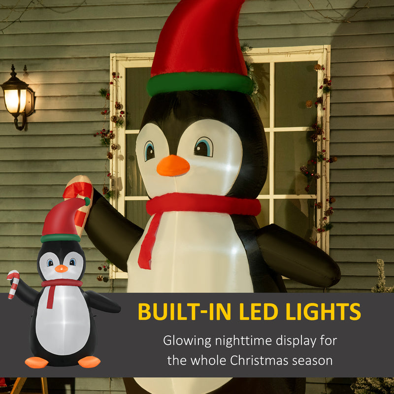 Inflatable penguin Christmas display with built-in LED lights in front of a house.