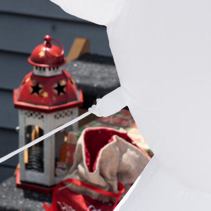 Decorative lantern with red top and black stars on a gray surface.