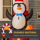Inflatable penguin decoration with Christmas elements on a house exterior.