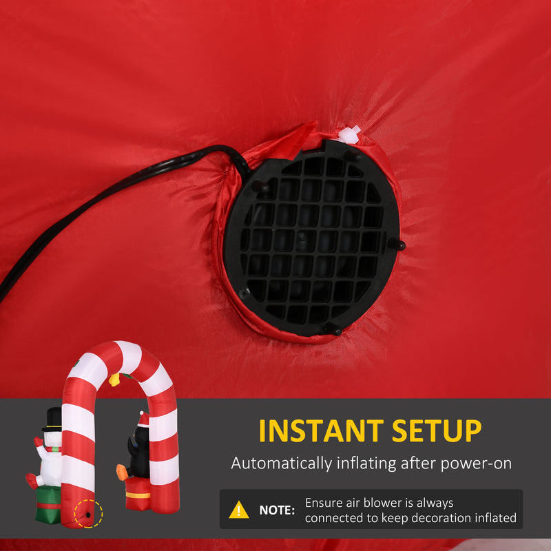 Red inflatable decoration with air blower and candy cane arch, featuring text about instant setup.