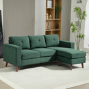 Green sectional sofa in a living room with a rug and furniture.