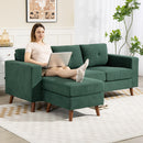 Green sectional sofa in a living room setting with wooden floor and decor.