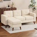 Cream White sectional sofa with wooden legs in a room with light wood flooring and white blinds.