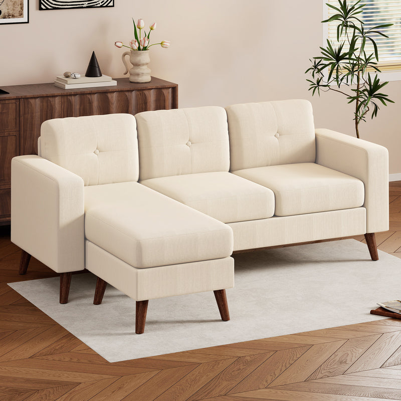 Cream White sectional sofa with wooden legs in a room with light wood flooring and white blinds.