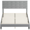 Gray upholstered bed frame with wooden slats on a white background