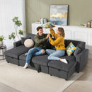 Two people sitting on a gray sectional sofa in a living room.