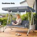 Person using a laptop on a swing with cushions and canopy, outdoors.