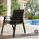 Black stackable chair on a patio with pool and garden in the background