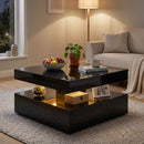 Modern living room with a black coffee table, fruit bowl, and decorative items.