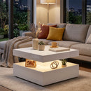Modern living room with a gray sofa, white square coffee table, and decorative items.