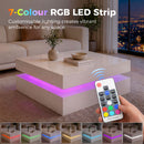 Living room with a modern white coffee table featuring an RGB LED strip and remote control, displaying customizable lighting options.