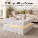 Modern living room with a high-gloss coffee table and decorative items.