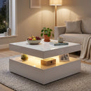 Modern living room with a square shaped white coffee table, sofa, and decorative items.