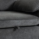 Close-up of a dark gray textured fabric sofa cushion with a ribbed corduroy-like surface, showing part of the seat, backrest, and a matching pillow.