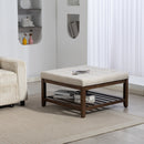 Beige ottoman with wooden frame in a living room setting