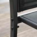 Close-up of a black metal chair with mesh backrest on a wooden floor.