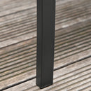 Black metal outdoor furniture leg on a wooden surface