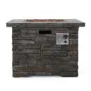 Stacked stone outdoor fire pit table with grill on a white background