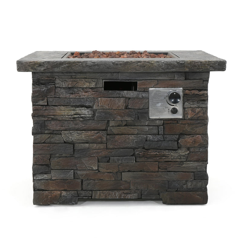 Stacked stone outdoor fire pit table with grill on a white background