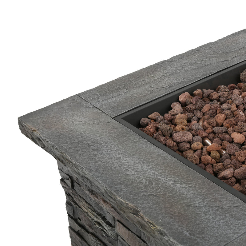 Stone fire pit with decorative rocks on a white background