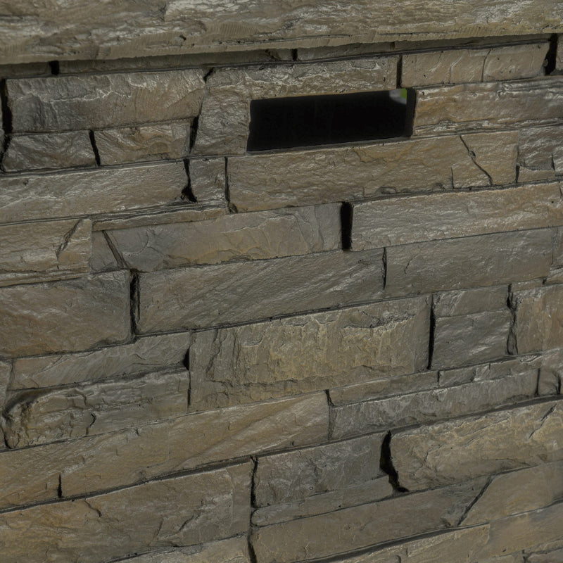 Close-up of a stone fire pit side wall with varying stone sizes and colors.