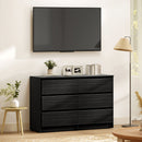 Black dresser with 6-drawers, decorative items in a living room setting