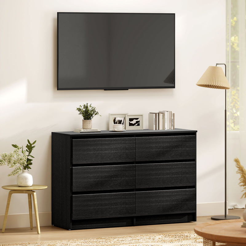 Black dresser with 6-drawers, decorative items in a living room setting