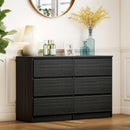 Black dresser with 6 Roller Drawers decorative items in a room with a mirror and plant.