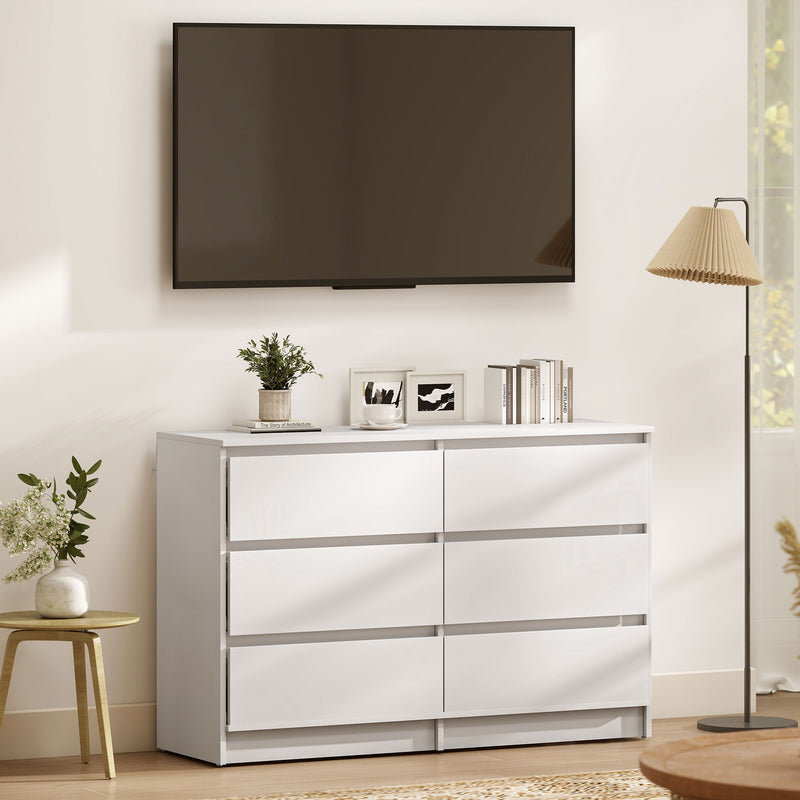 White dresser with decorative items in a living room setting