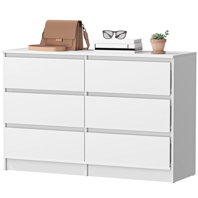 White dresser with a brown bag, glasses, and a plant on top against a white background