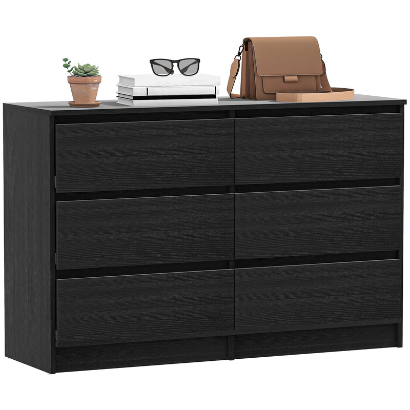 Black dresser with decorative items on top against a white background