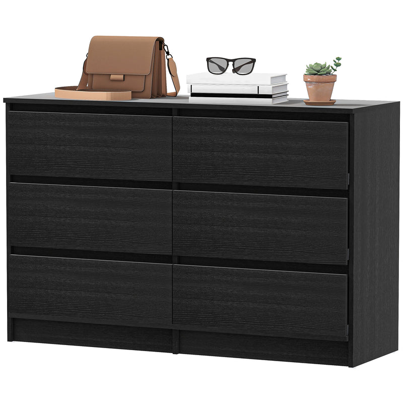 Black dresser with a brown bag, glasses, and a plant on top against a white background