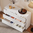 White dresser with open drawers containing various items in a room setting.