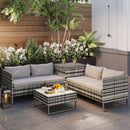 4 seat outdoor patio furniture sofa with cushions and a small table on a patio.