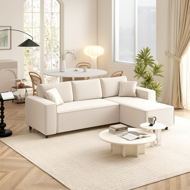 Beige sectional sofa in a living room with a coffee table and decor items.