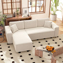 White sectional sofa in a living room with a glass coffee table and decorative items.