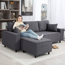 Woman reading a book on a gray sectional sofa in a living room.